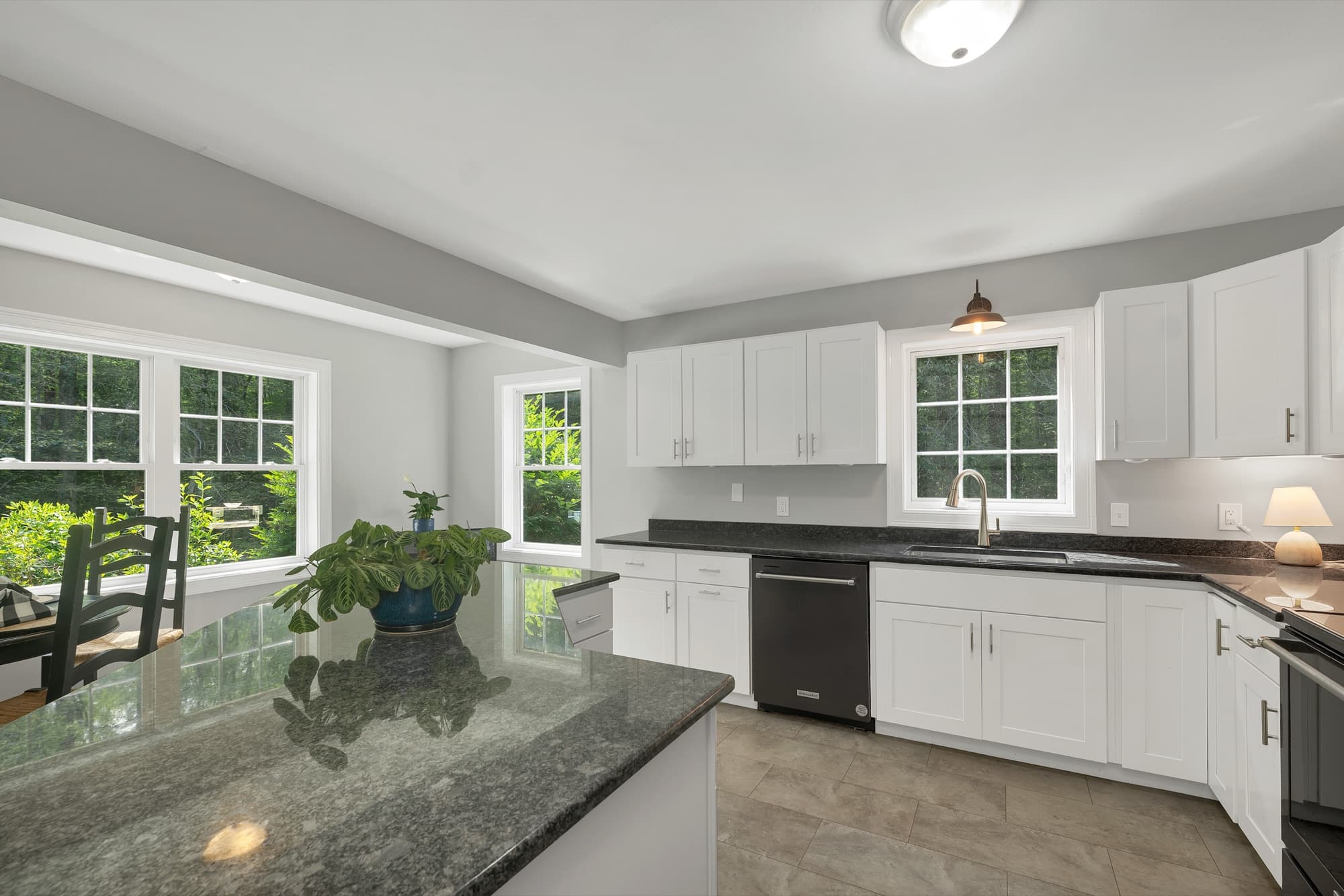 Granite counters and stainless-and-black appliances in the kitchen