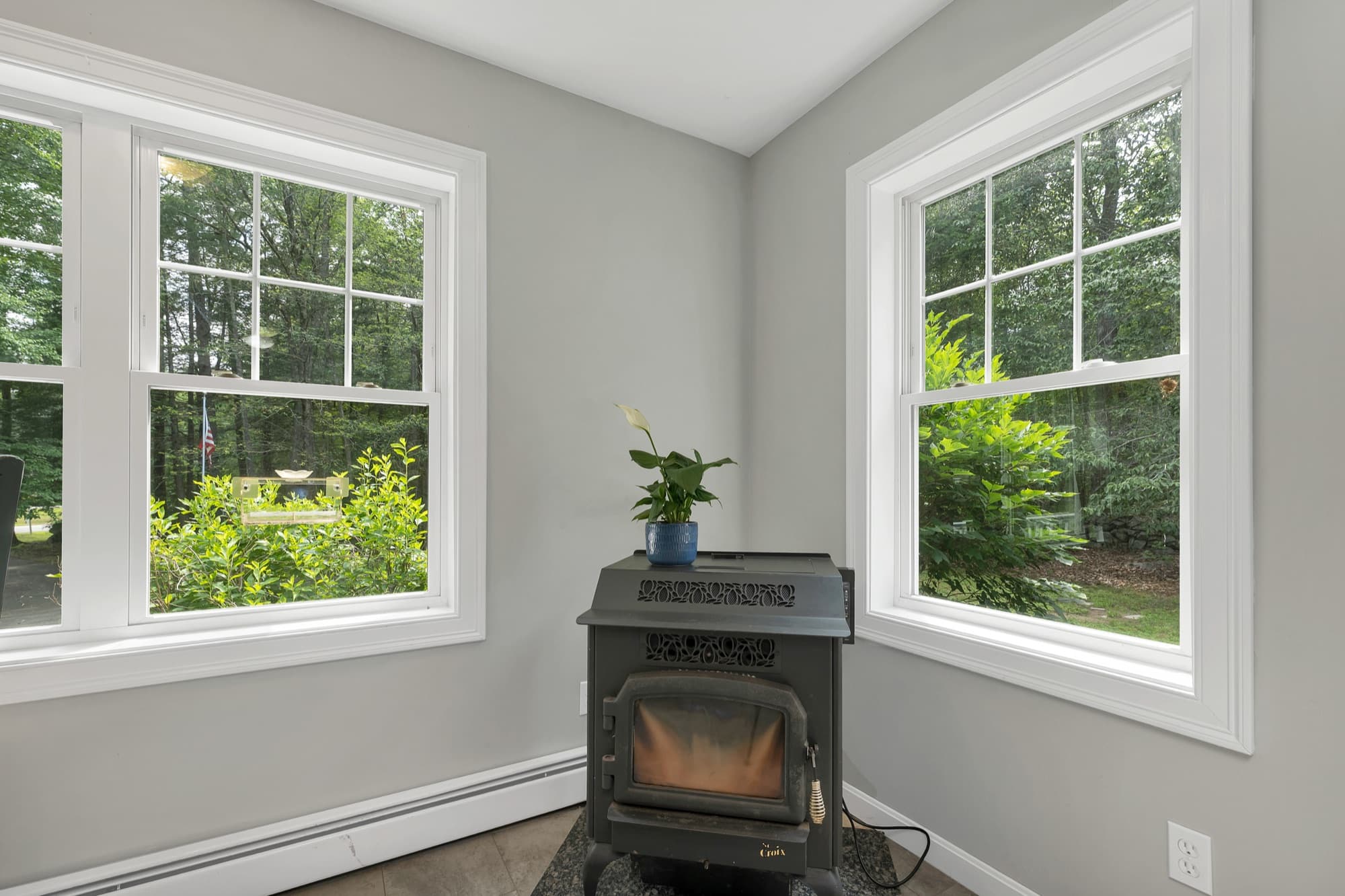 Pellet stove set into the corner windows
