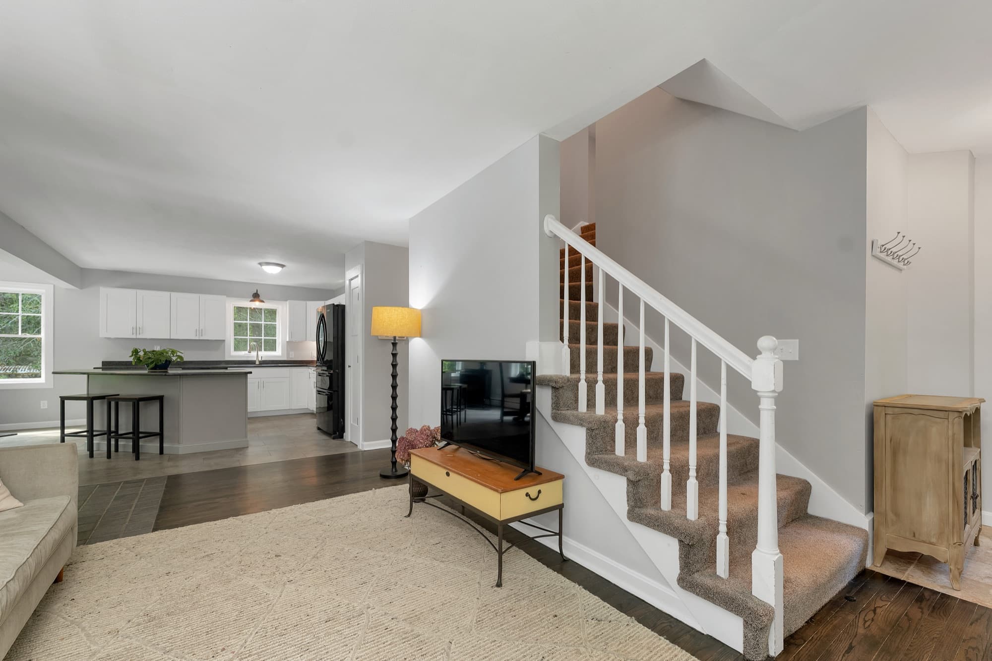 Staircase to the second floor, with the open first-floor plan beyond