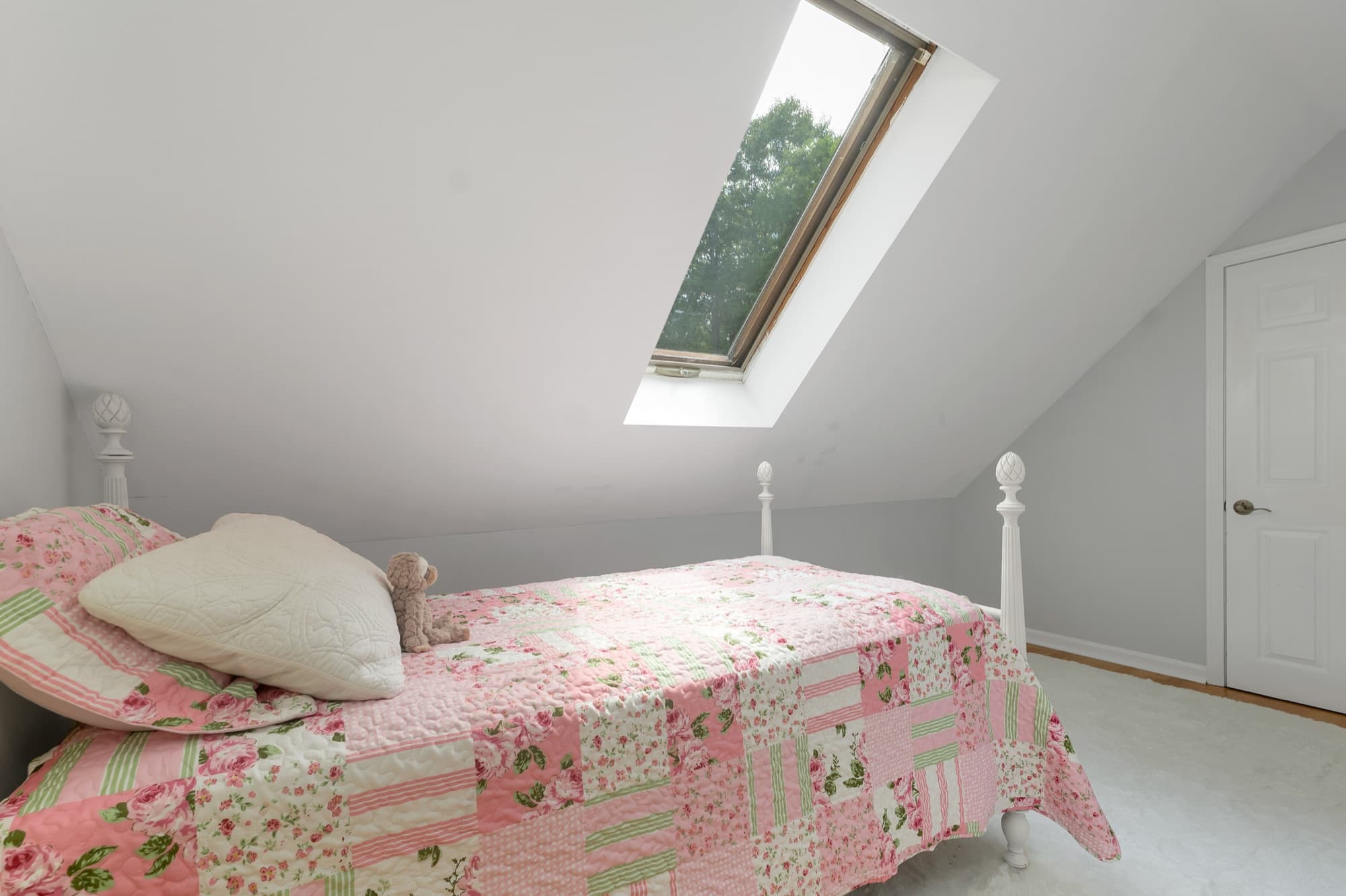 Second-floor bedroom under the Cape roofline, with a skylight