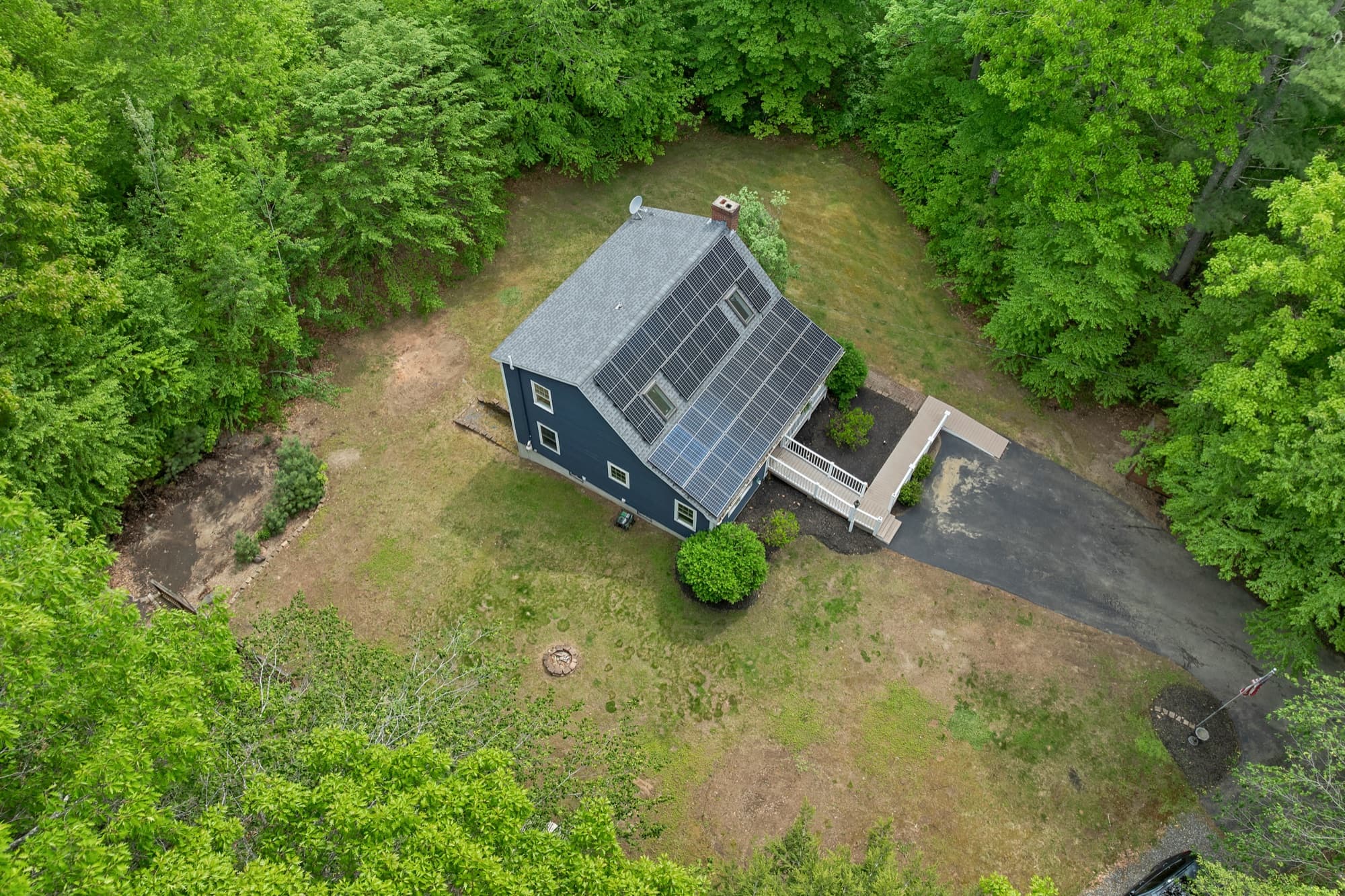 Aerial view of the house and its 2.22 wooded acres